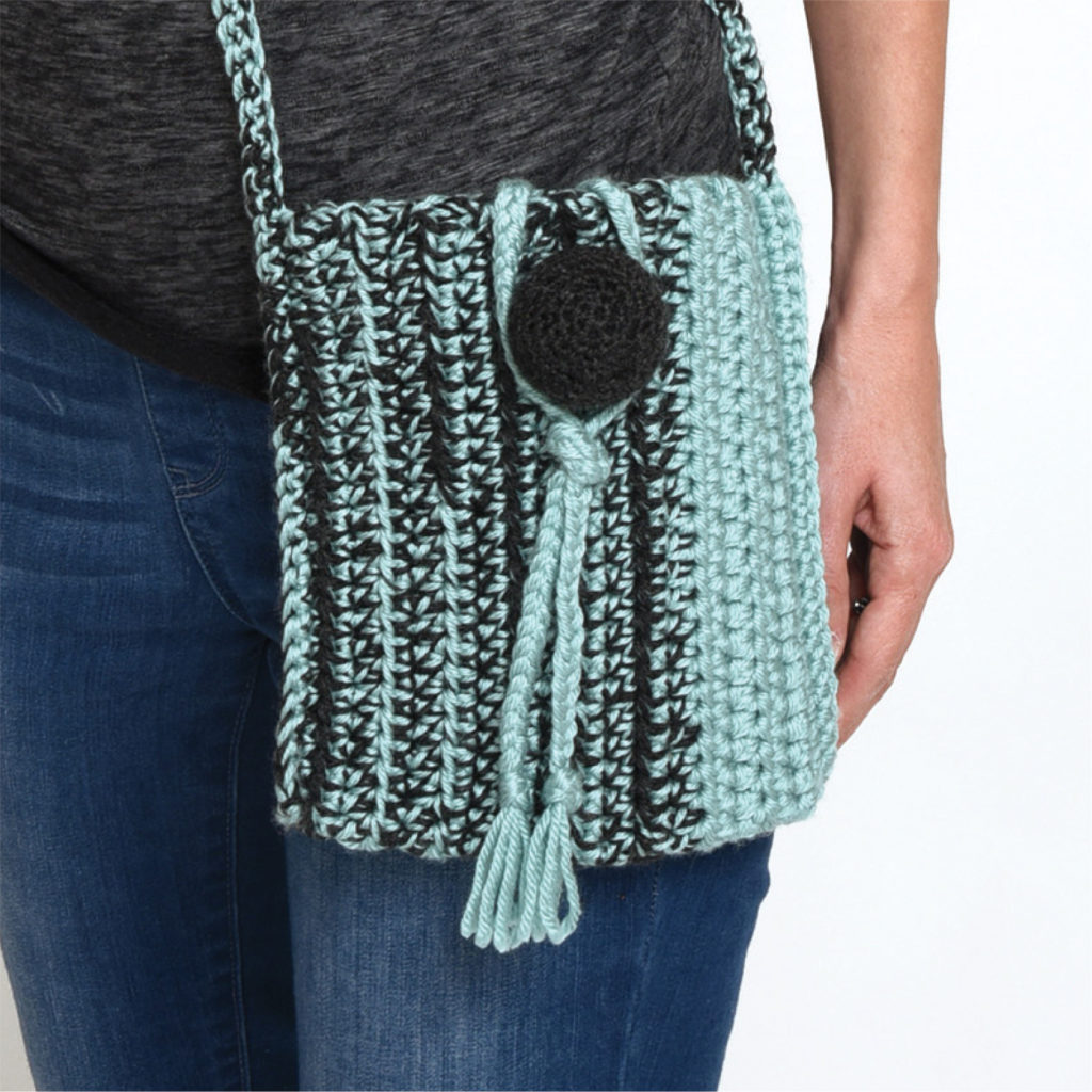 The Ball Button Crossbody Bag is a fun purse with a clever 3-dimensional ball closure.