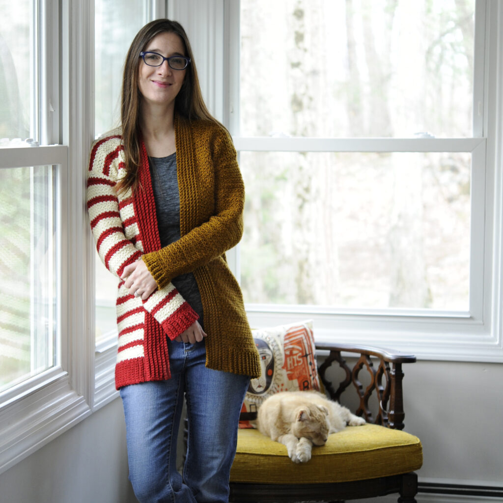 A woman wearing the Stripe Block Cardigan.  A project designed in a Stitches Events class with Jim Cox.
