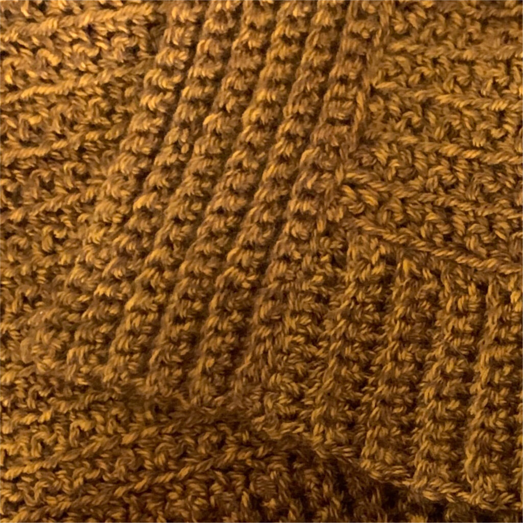 Close-up of ribbing on the edge of a crochet cardigan.