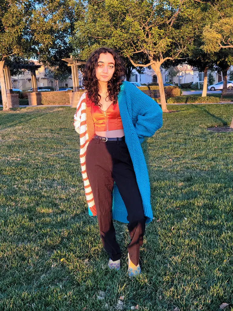 Woman modeling an oversized version of a funky, unique crochet cardigan.