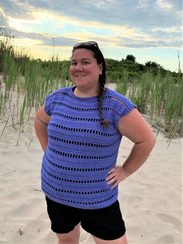 A woman wearing a blue ladies crochet top pattern. The top is modeled by Trista of Trista of Crochets and can be purchased on Etsy.