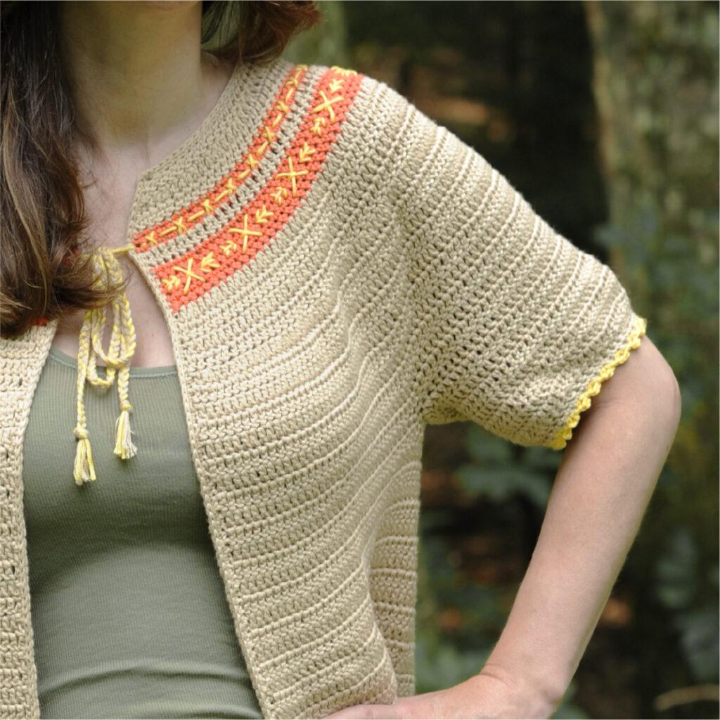 A close up of the short sleeve of the crochet cardigan pattern ideal for summer.