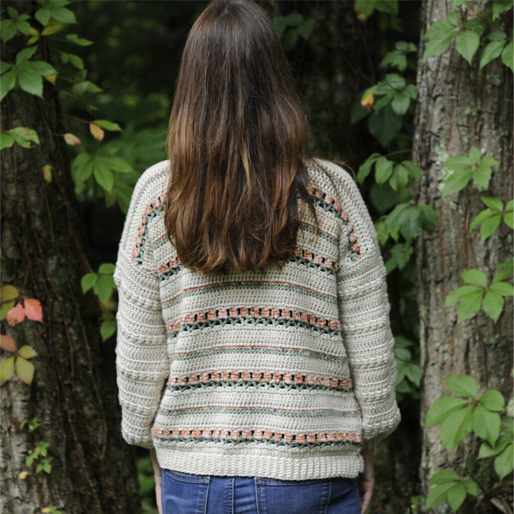 Back of the Roses on Repeat Sweater.  I think you will have a blast getting your creative juices flowing picking out colors for the little flowers and body.