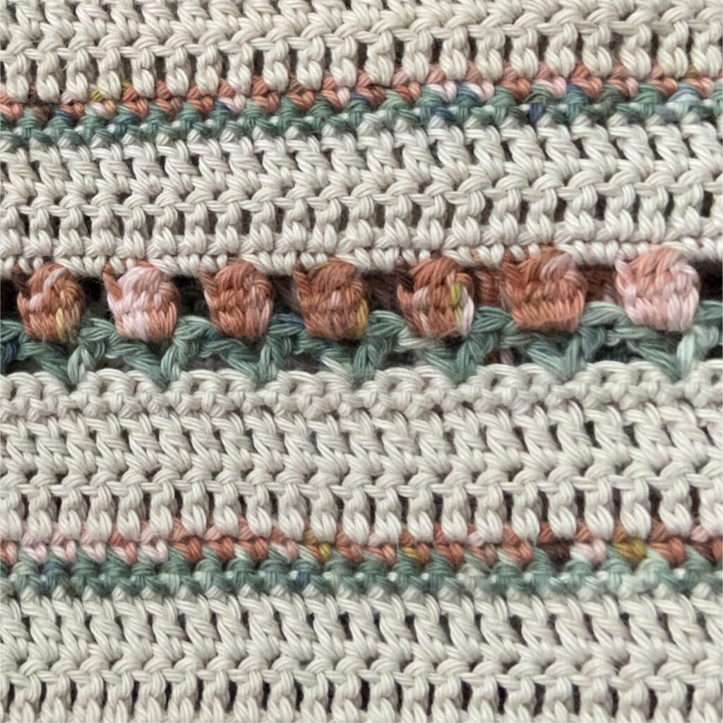 Close up of the Roses on Repeat Sweater. A fun, interesting, relaxing crochet sweater pattern.