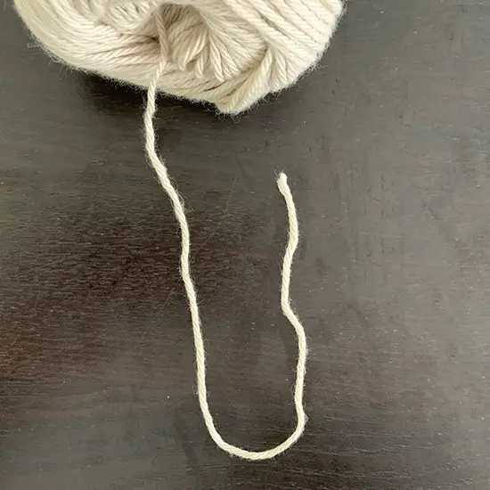A piece of yarn in the shape of a U.