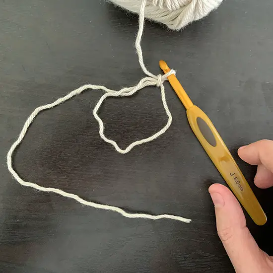 A crochet magic ring with one chain attached.