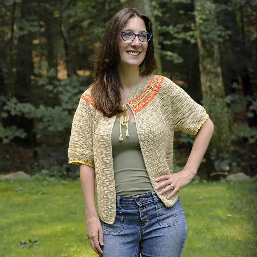 Mary Beth from Crochet with Mary Beth modeling the In Stitches Cardigan, a crochet garment made with Coboo yarn.