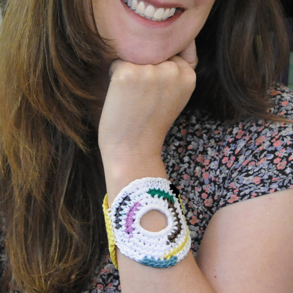 Woman's arm showing a crochet bracelet made from the crochet bracelet pattern, Circle Around Bracelet.