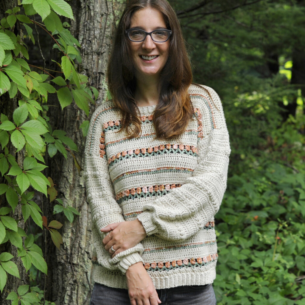 The Roses on Repeat Sweater worn by Mary Beth has the same pretty tulip pattern as the modern crochet scarf featured in this post.