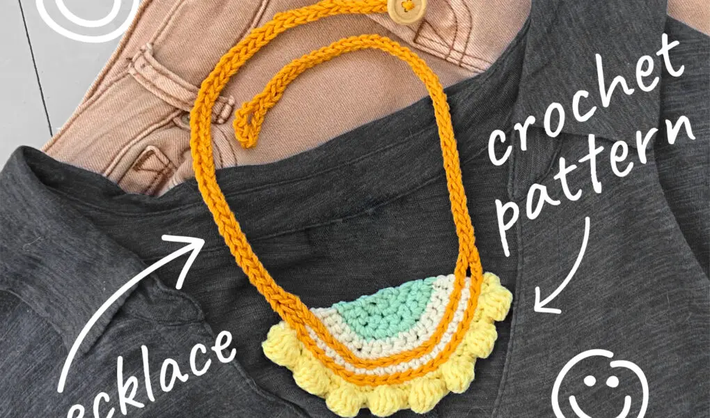 The Eight Bobble Crochet Necklace made from a pattern. White, blue, yellow necklace with gold yarn chain.