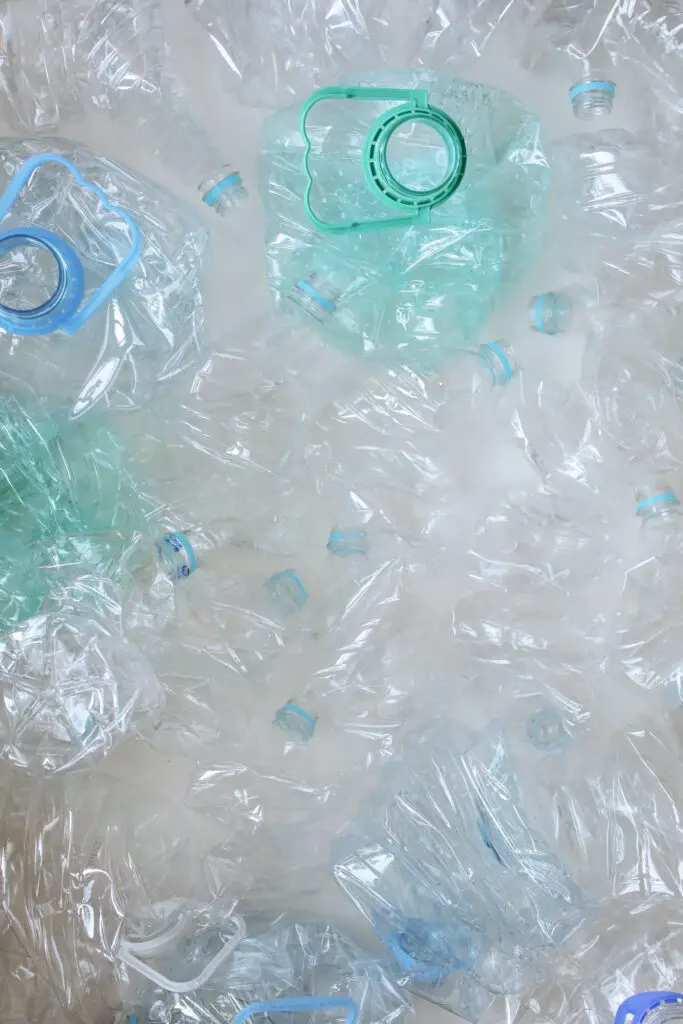 A pile of plastic bottles that can be made into recycled plastic yarn.