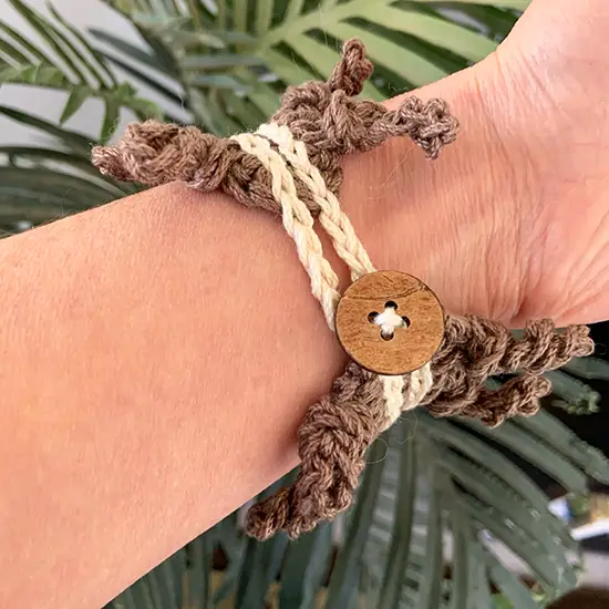 The clasp of this crochet bracelet pattern is a simple button and chain.