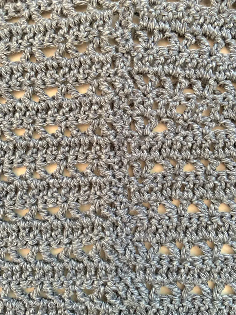 Close-up of a crochet seam on the side of a crochet sweater. The type of seam is a single crochet stitch seam.